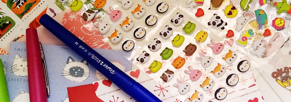 Photo of sticker sheets, marker pens, and a variety of stationery.